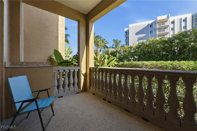 a living room with furniture and a kitchen