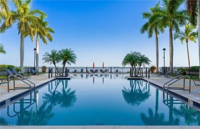 a view of swimming pool with a table and chairs