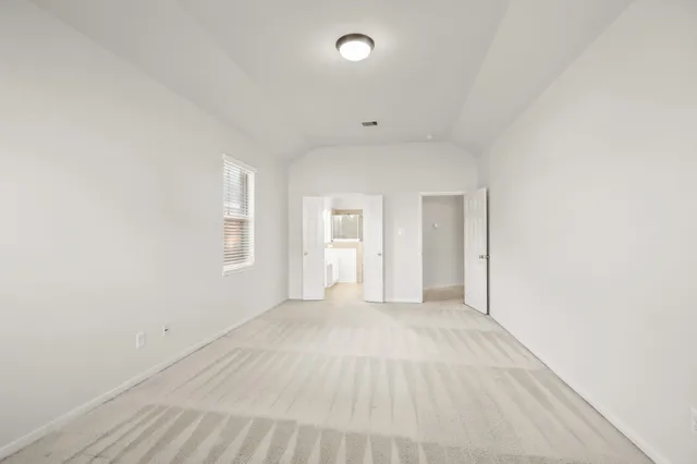 an empty room with windows and closet