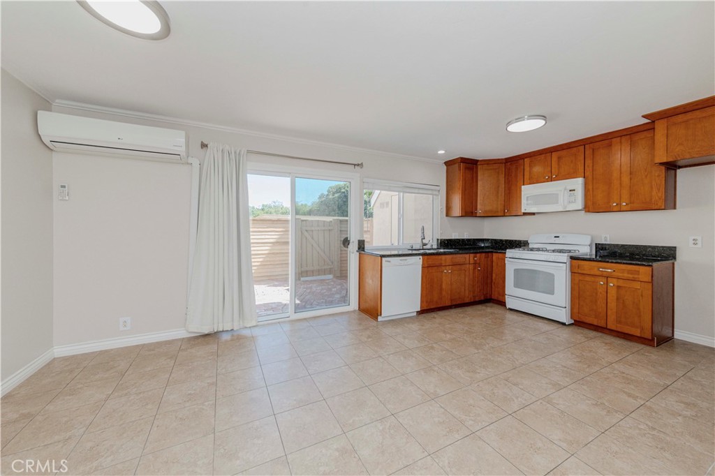 49 Meadowgrass Irvine, CA 92604 - Photo 7 of 25 a kitchen with stainless steel appliances granite countertop a stove top oven a sink and dishwasher