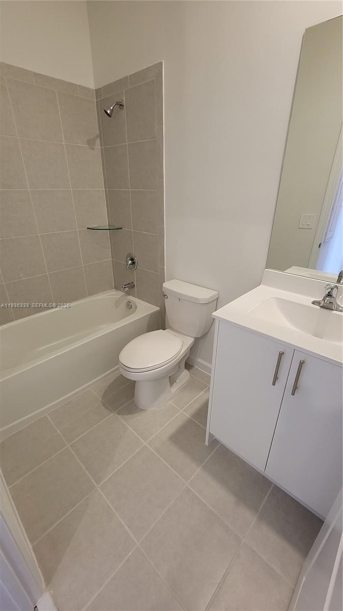 26430 Southwest 148th Court, Unit 26430 Homestead, FL 33032 - Photo 13 of 21 a bathroom with a sink a toilet and shower