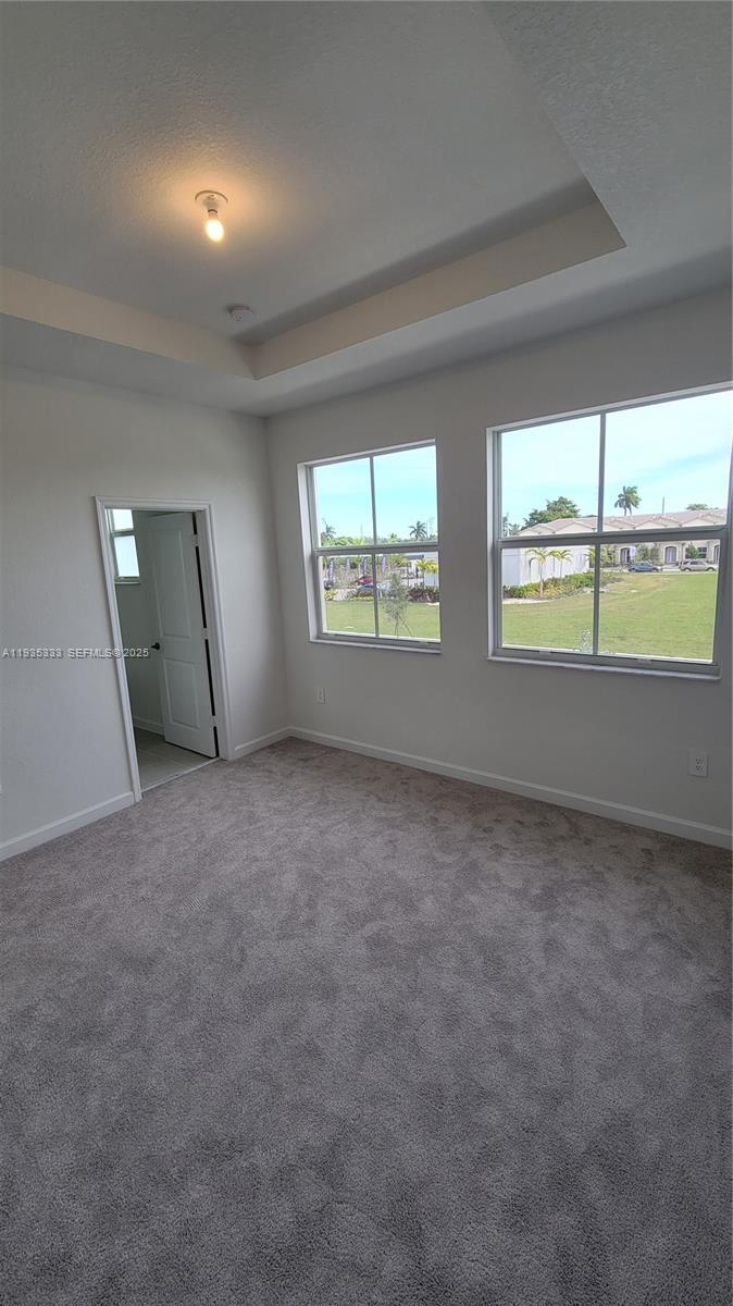 26430 Southwest 148th Court, Unit 26430 Homestead, FL 33032 - Photo 16 of 21 an empty room with windows