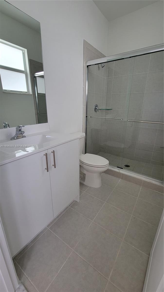 26430 Southwest 148th Court, Unit 26430 Homestead, FL 33032 - Photo 17 of 21 a bathroom with a toilet a sink and shower