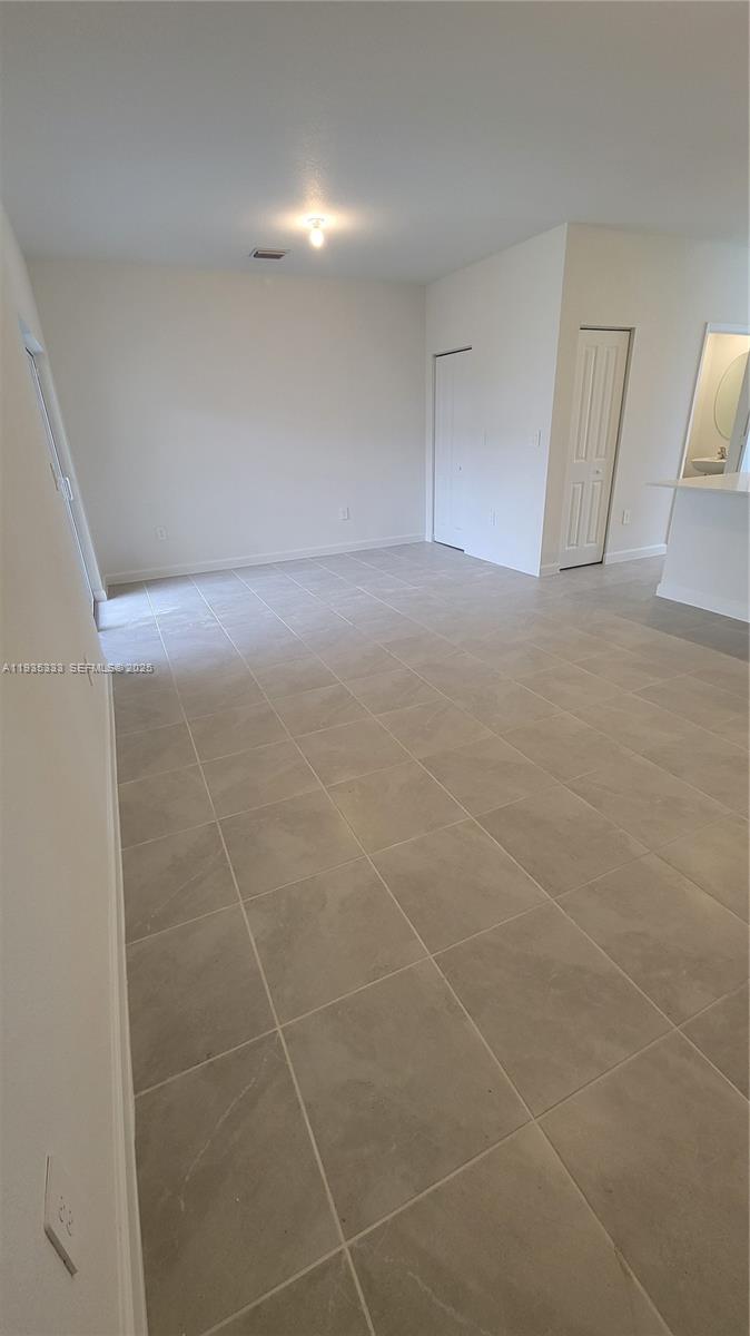 26430 Southwest 148th Court, Unit 26430 Homestead, FL 33032 - Photo 7 of 21 a view of an empty room