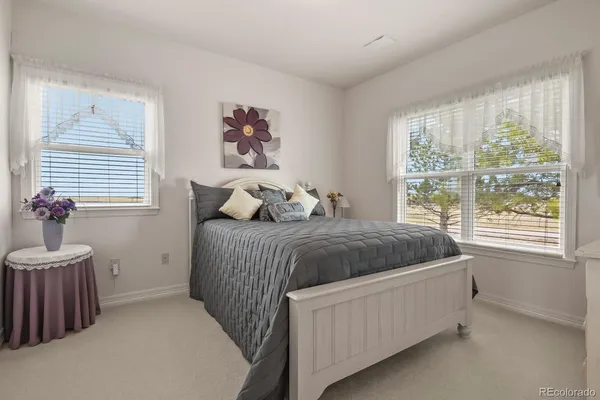 a bedroom with a bed and a potted plant