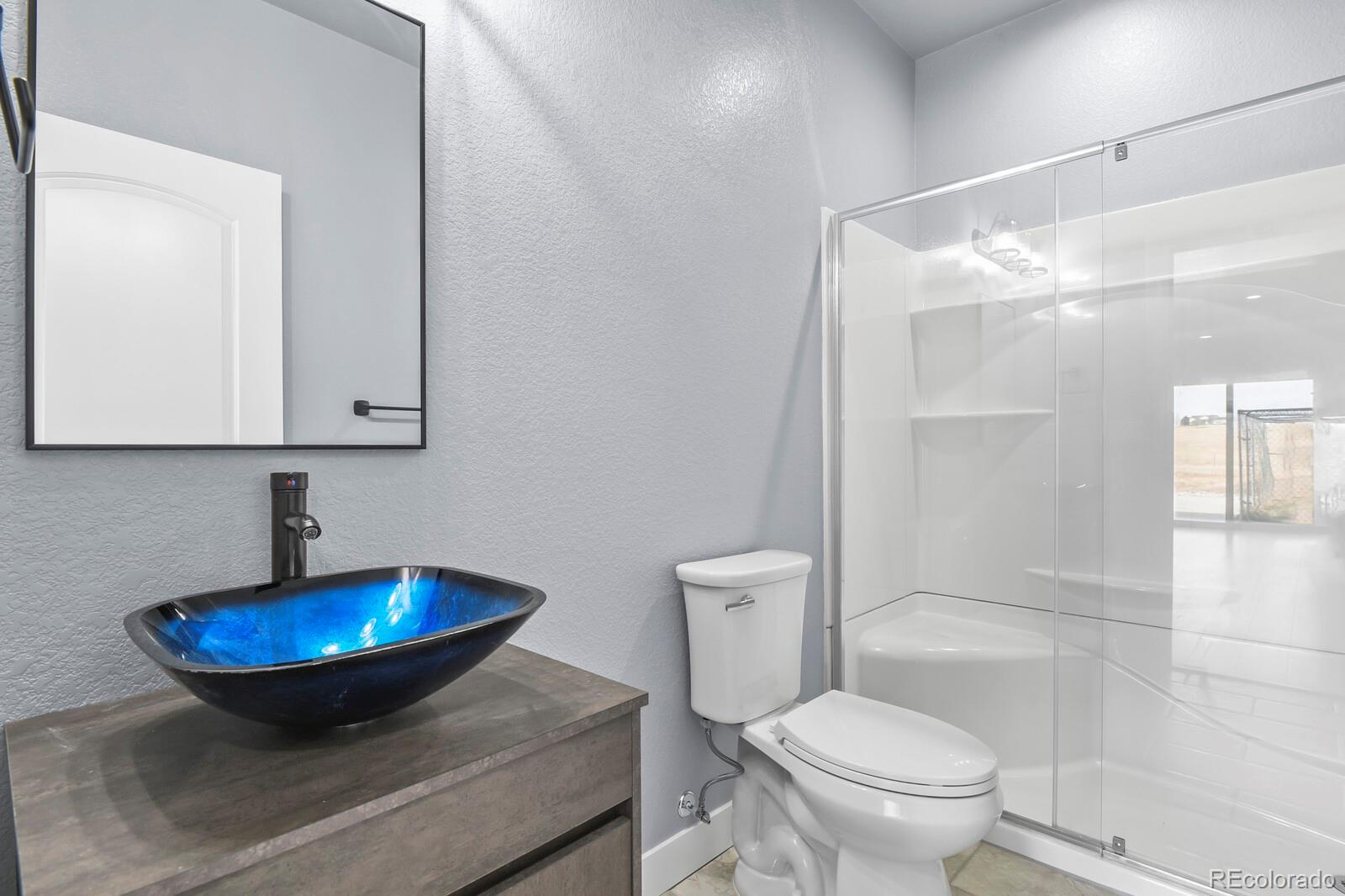 26846 Richards Circle Elbert, CO 80106 - Photo 39 of 49 a bathroom with a sink toilet and shower