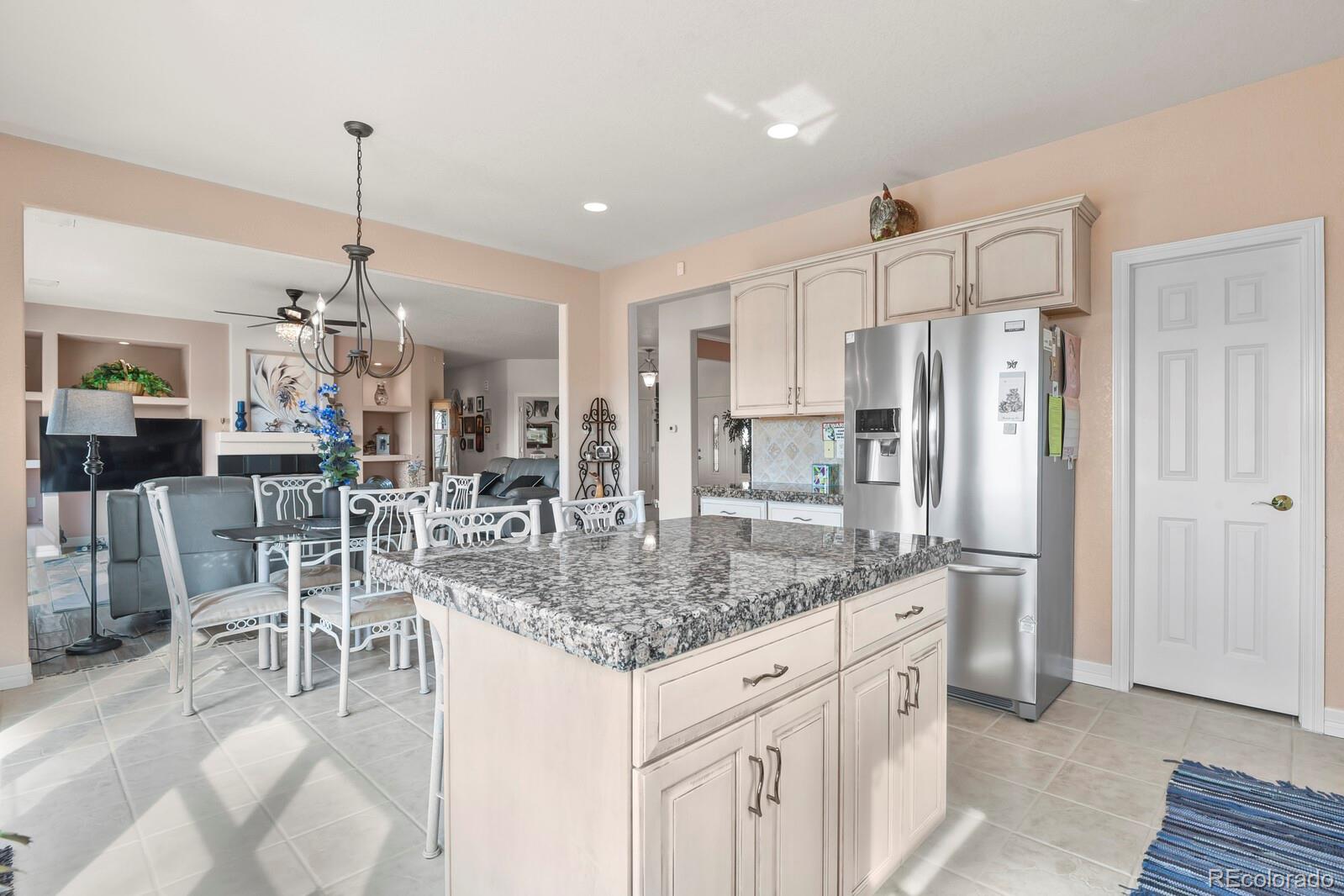 26846 Richards Circle Elbert, CO 80106 - Photo 5 of 49 a kitchen with stainless steel appliances kitchen island granite countertop a refrigerator and microwave