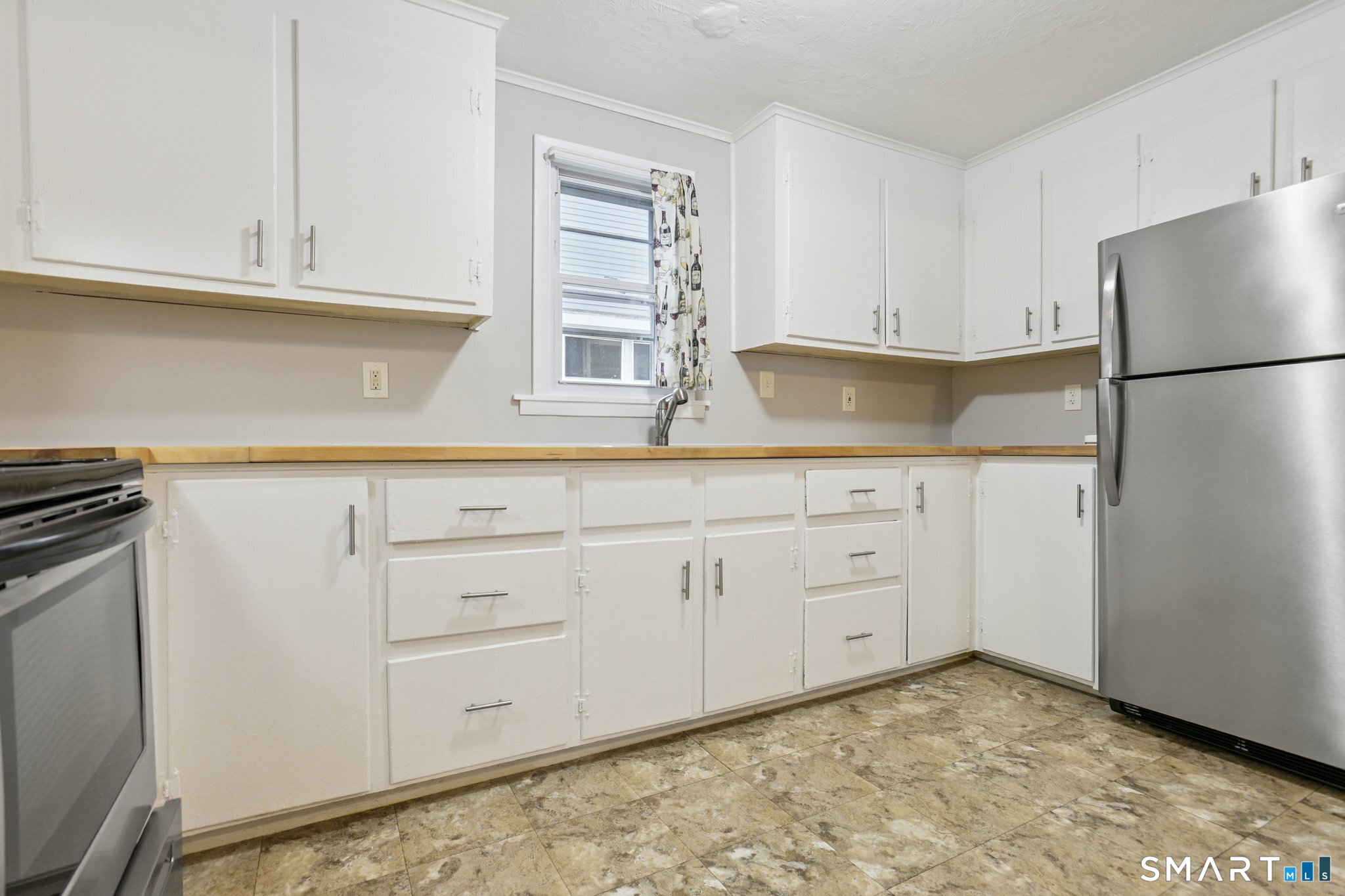 41 Fountain Street Norwich, CT 06360 - Photo 13 of 30 a kitchen with white cabinets and refrigerator