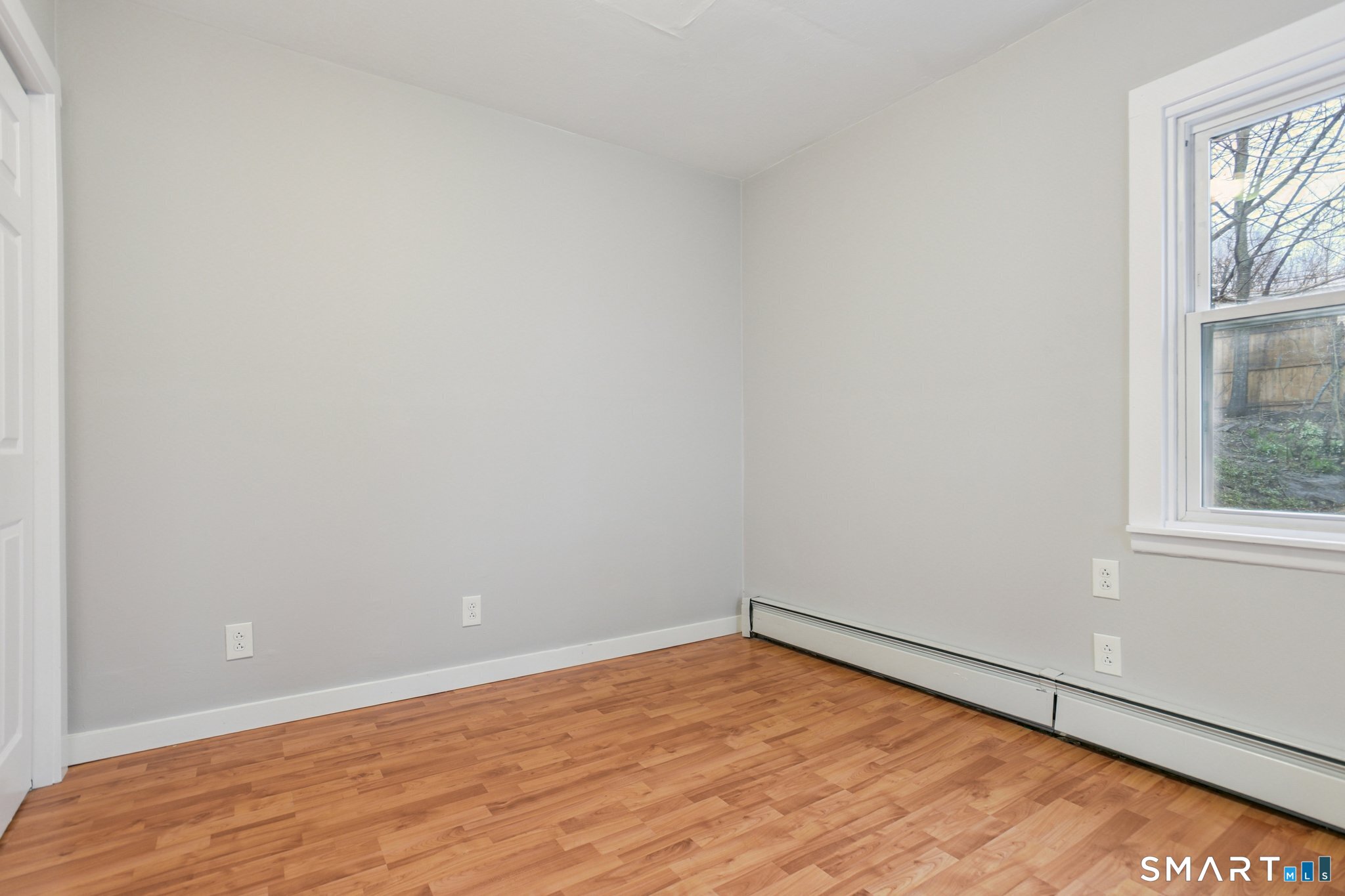 41 Fountain Street Norwich, CT 06360 - Photo 16 of 30 an empty room with wooden floor and windows