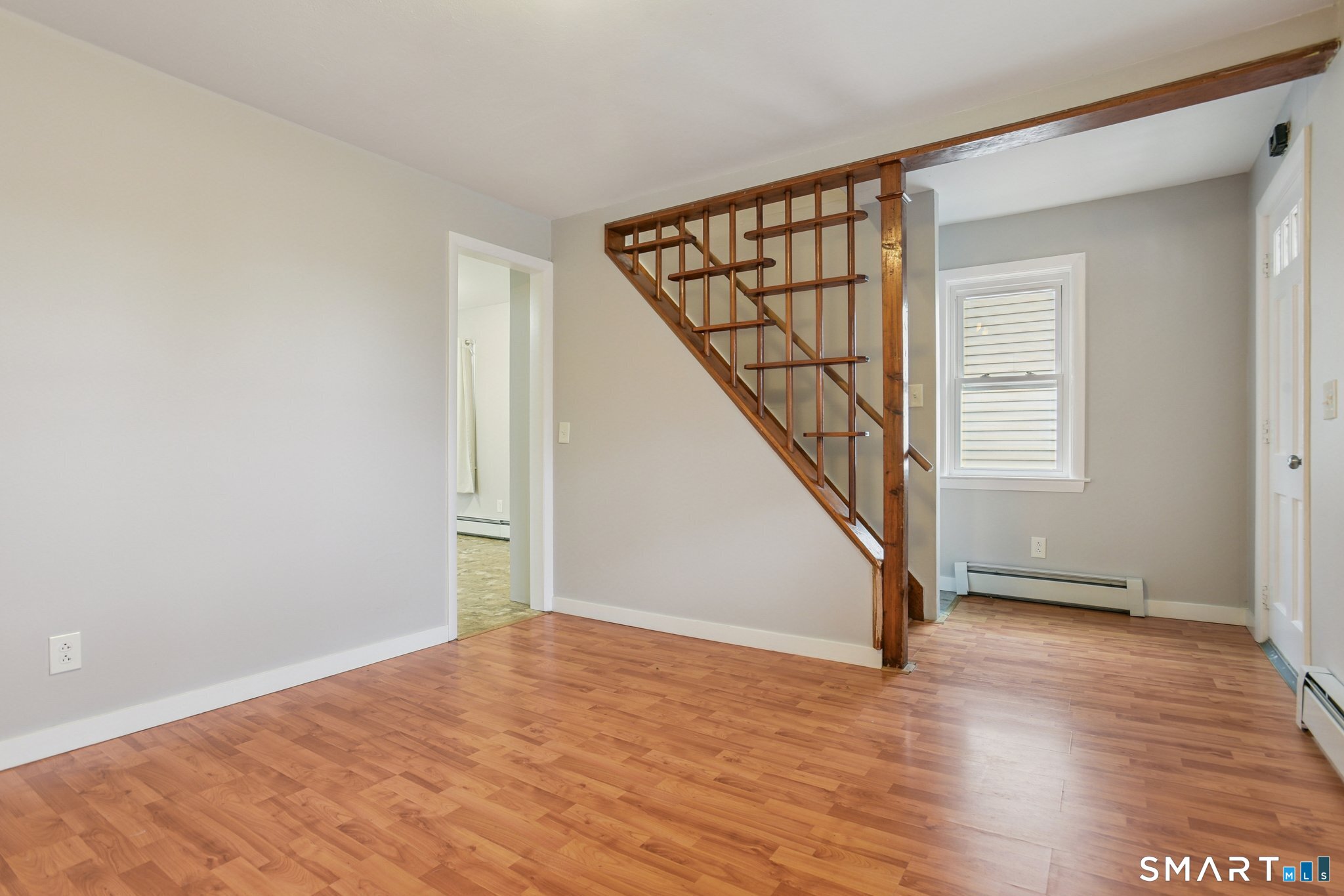 41 Fountain Street Norwich, CT 06360 - Photo 4 of 30 a view of an empty room with wooden floor and stairs