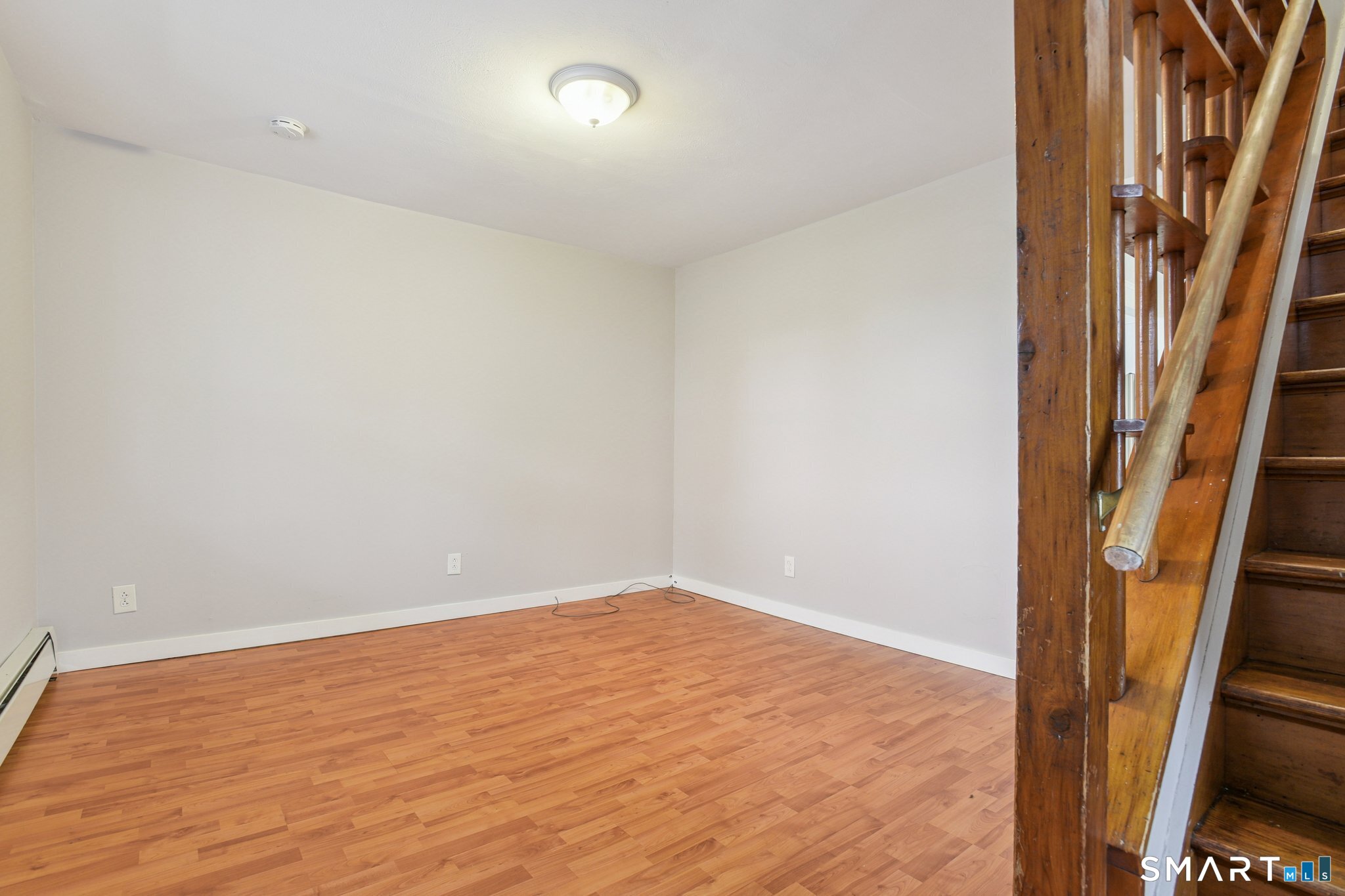 41 Fountain Street Norwich, CT 06360 - Photo 5 of 30 an empty room with wooden floor and entrance