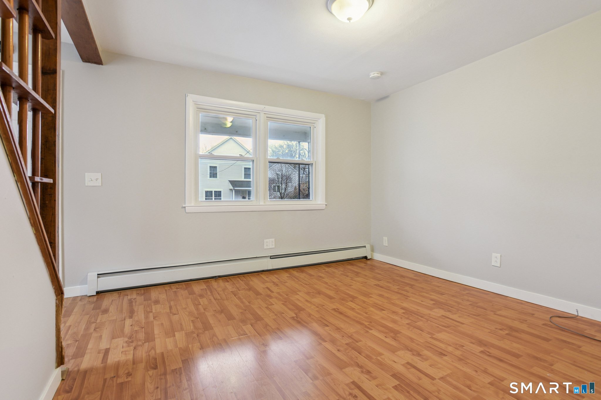 41 Fountain Street Norwich, CT 06360 - Photo 7 of 30 an empty room with wooden floor and windows
