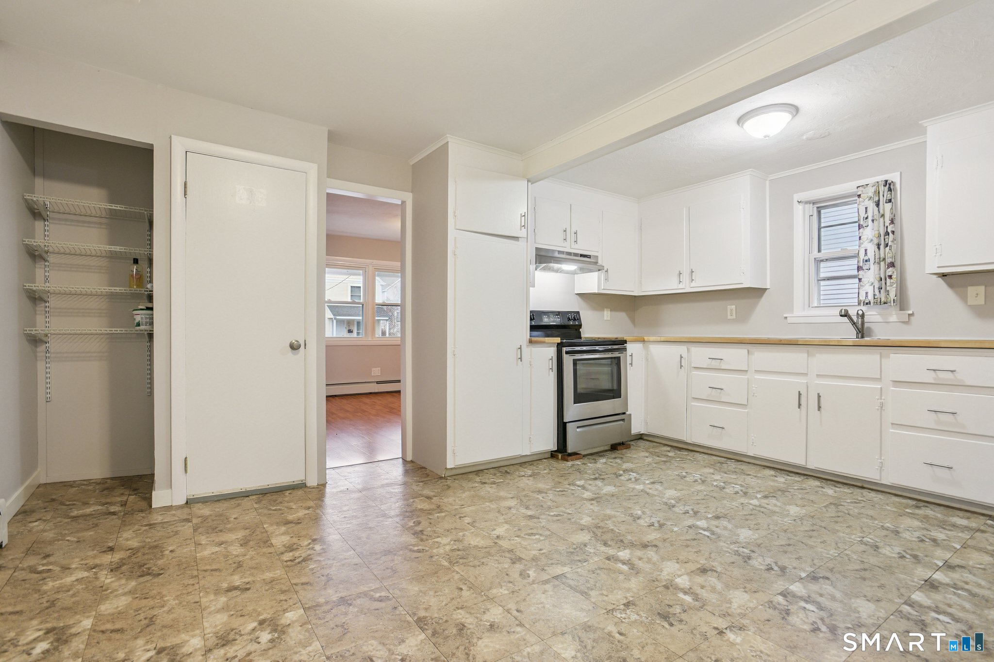41 Fountain Street Norwich, CT 06360 - Photo 8 of 30 a kitchen with white cabinets and white appliances