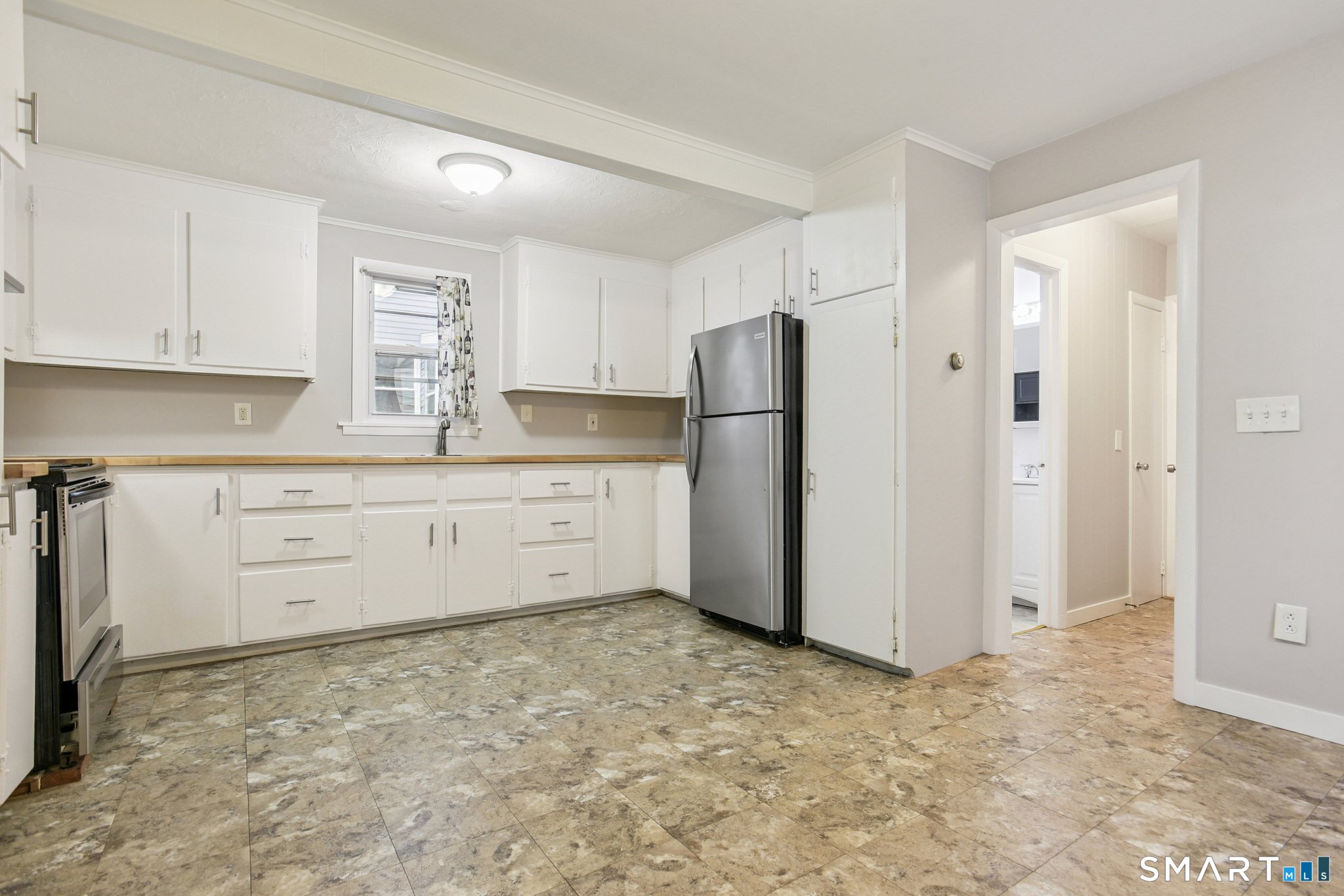 41 Fountain Street Norwich, CT 06360 - Photo 10 of 30 a kitchen with a refrigerator sink stove and cabinets