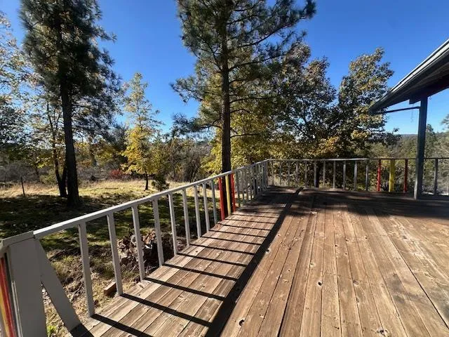 a view of balcony with wooden floor and fence