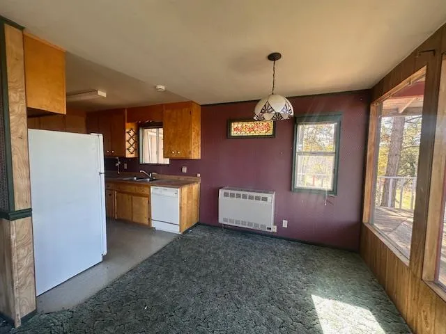 a kitchen with granite countertop white cabinets and stainless steel appliances