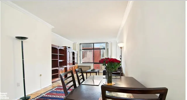 a living room with furniture and flowers