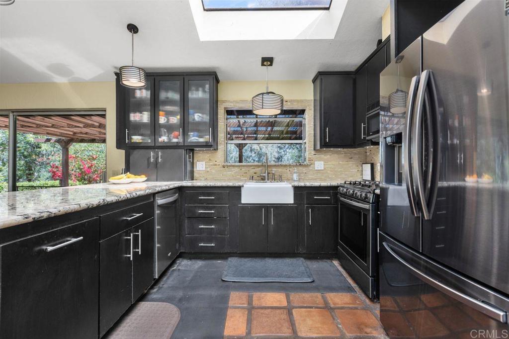 29560 Lilac Road Valley Center, CA 92082 - Photo 10 of 43 a kitchen with stainless steel appliances granite countertop a sink stove and refrigerator