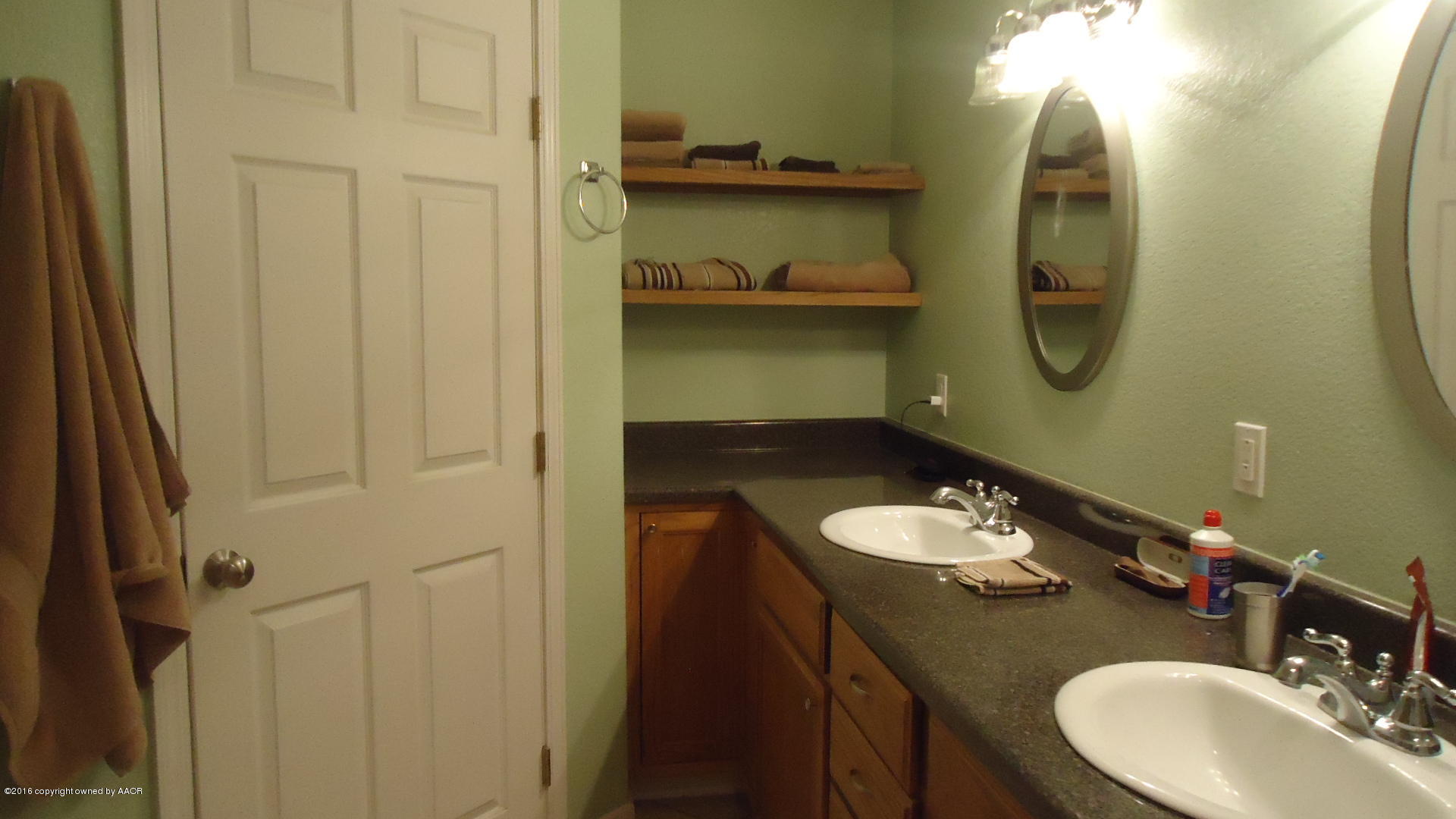 4412 South Austin Street Amarillo, TX 79110 - Photo 6 of 10 a bathroom with a granite countertop sink and a mirror