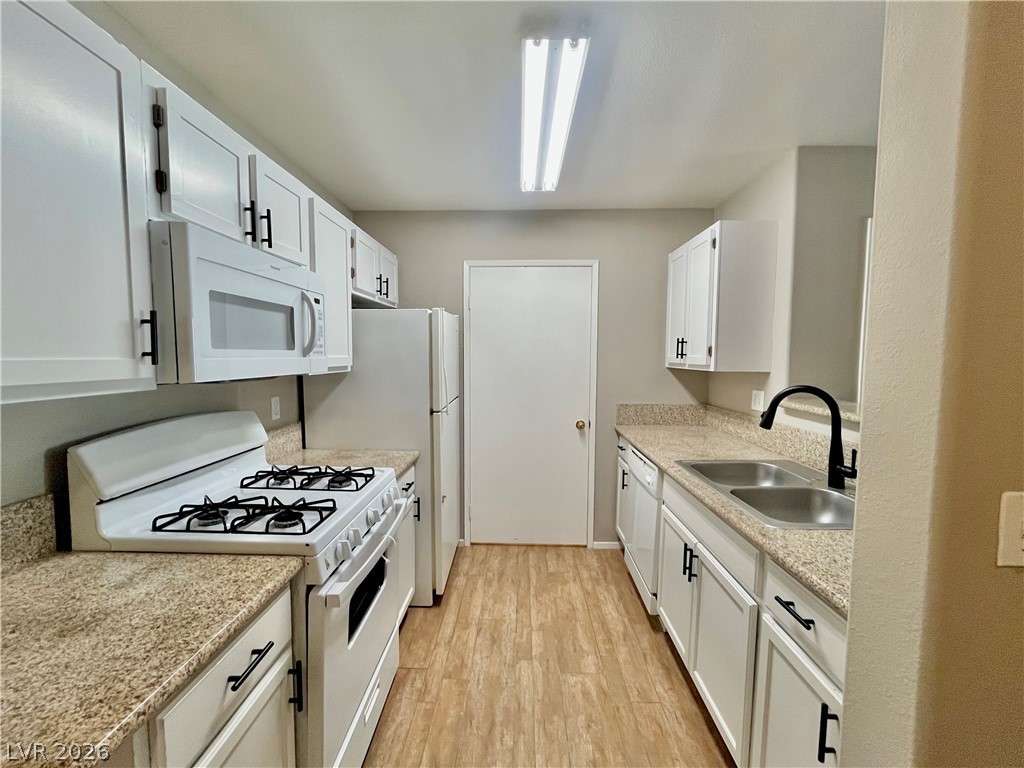 7885 West Flamingo Road, Unit 1029 Las Vegas, NV 89147 - Photo 7 of 18 Streamlined kitchen offers ample counter space and essential appliances for everyday cooking.