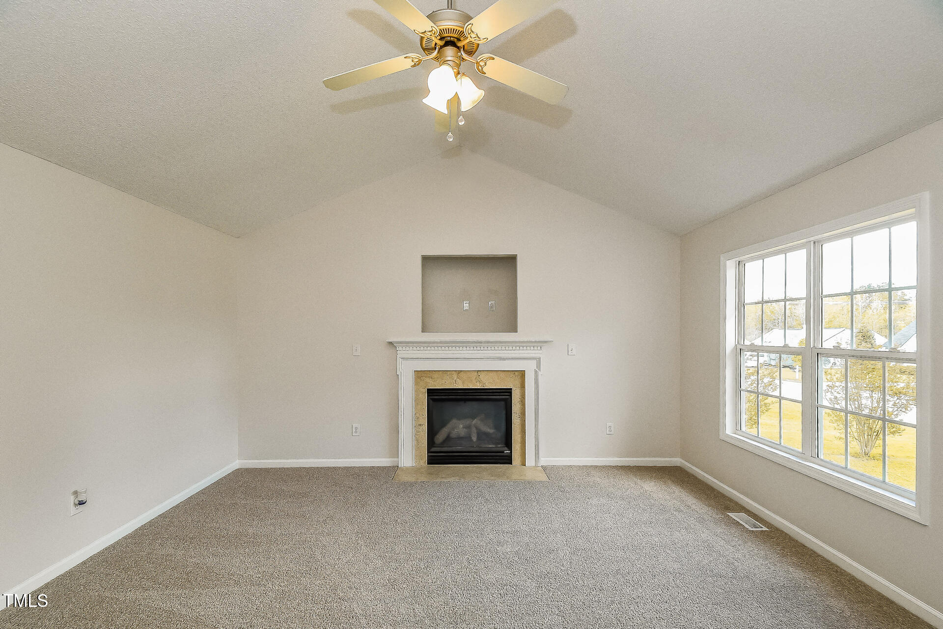1003 Walnut Drive Erwin, NC 28339 - Photo 3 of 16 a view of empty room with fireplace and fan
