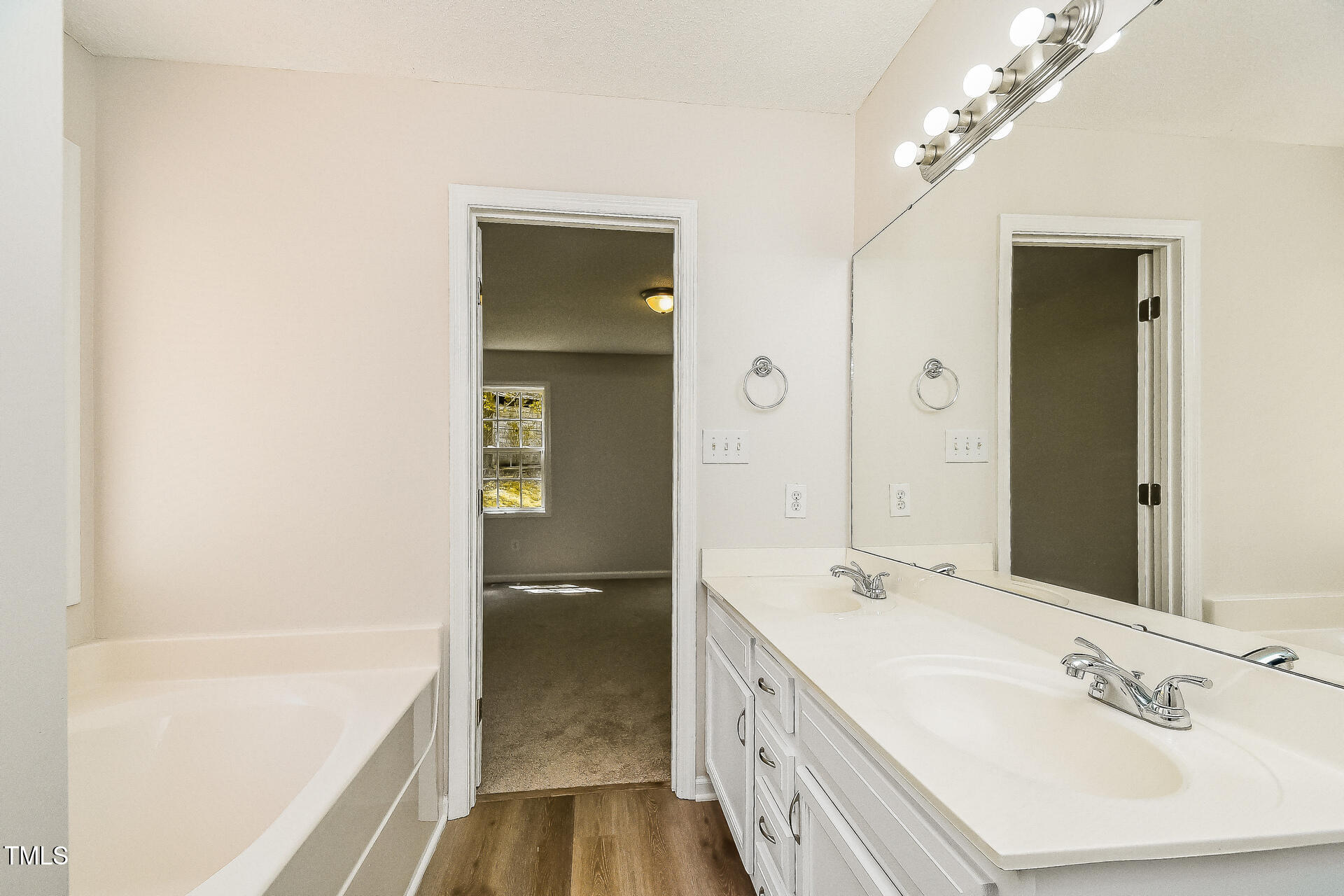 1003 Walnut Drive Erwin, NC 28339 - Photo 9 of 16 a spacious bathroom with a shower sink and mirror