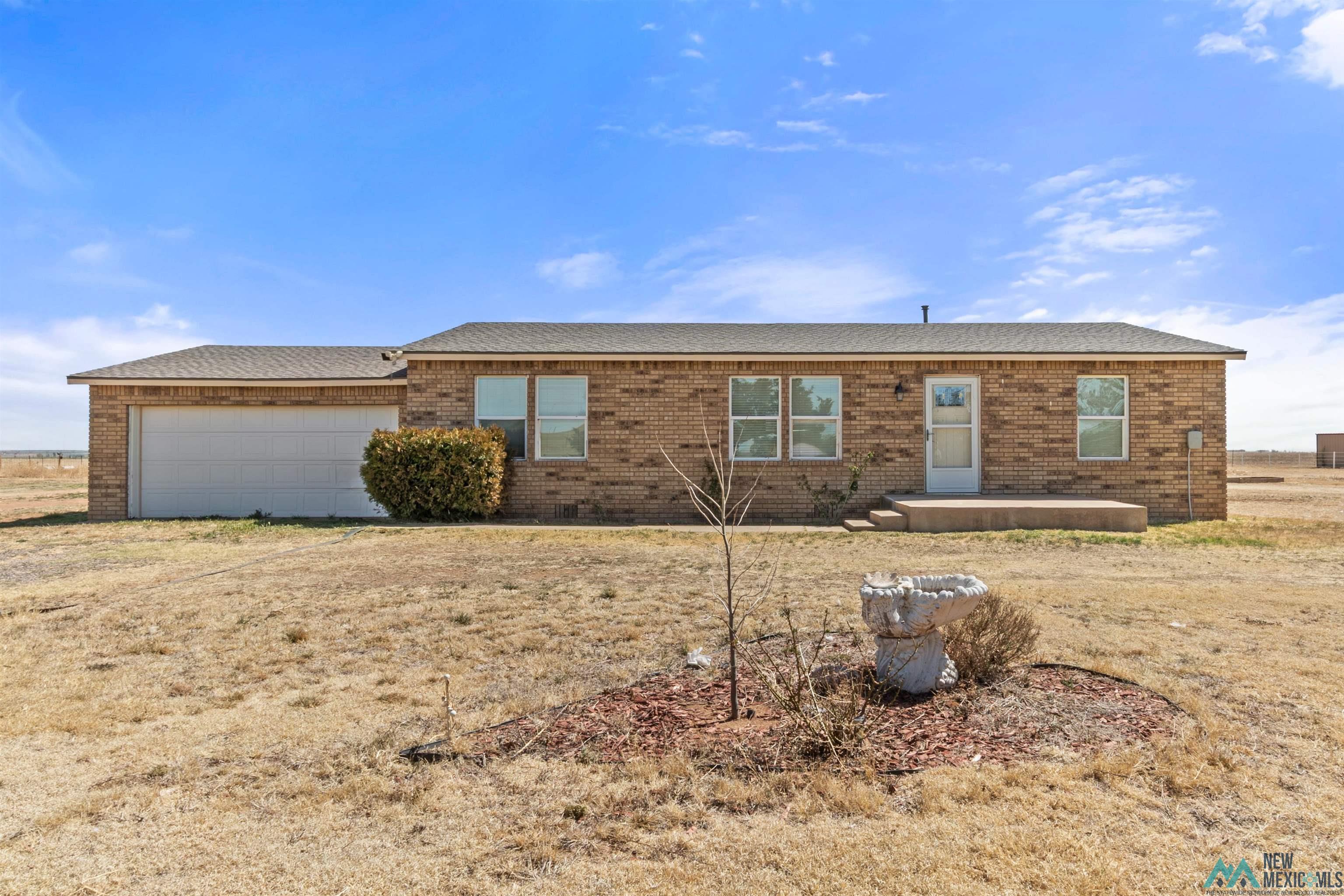 Single story home with brick siding and an attached garage