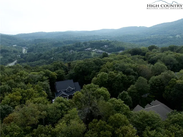an aerial view of a house with mountain view