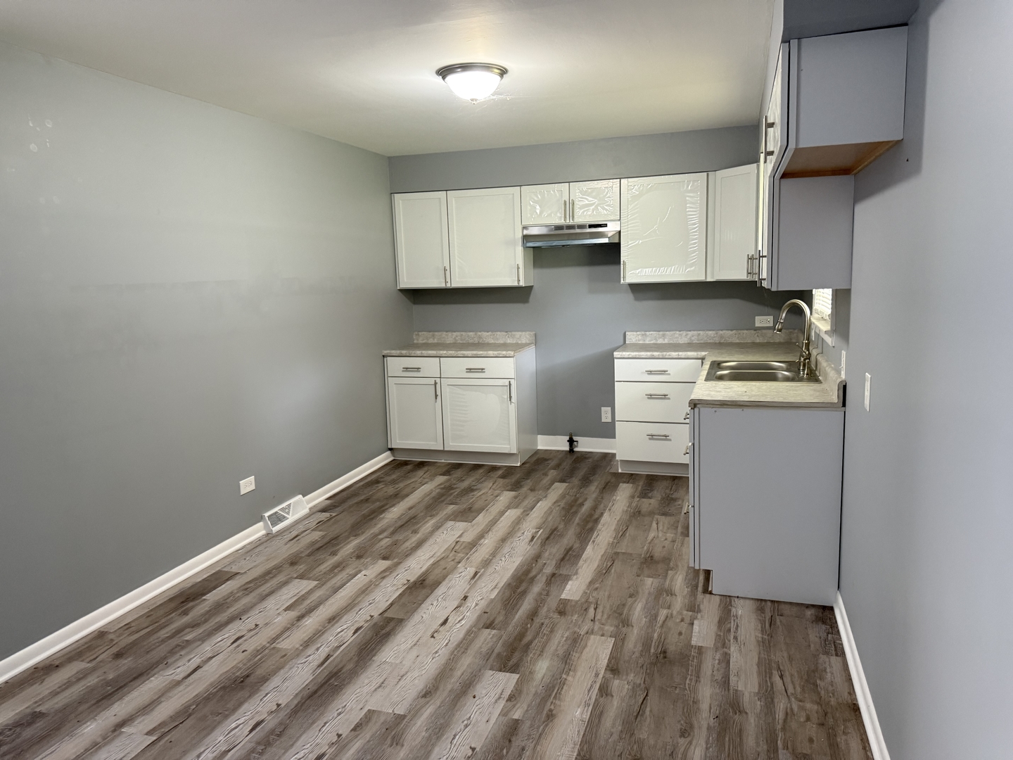 2352 West 157th Place Markham, IL 60426 - Photo 11 of 28 a kitchen with a stove and white cabinets