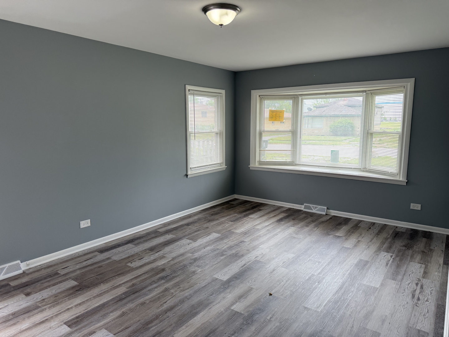 2352 West 157th Place Markham, IL 60426 - Photo 7 of 28 a view of an empty room with wooden floor and a window
