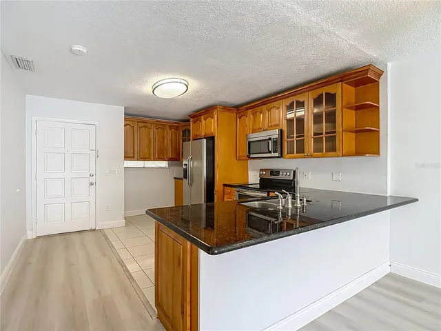 a kitchen that has a sink and a stove in it