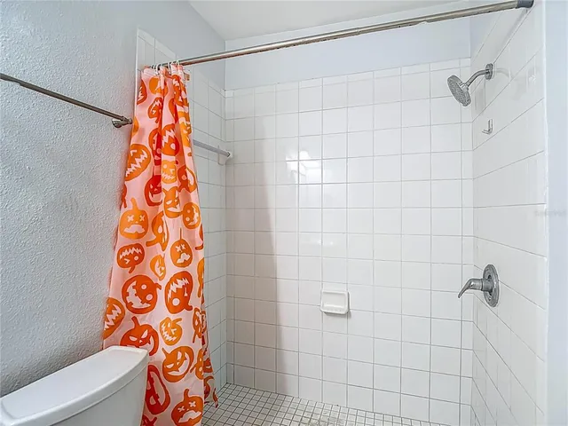 a bathroom with a shower and a shower curtain