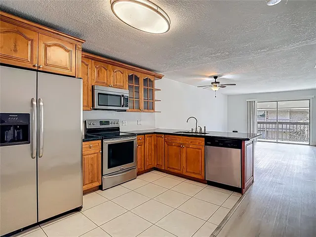 a kitchen with stainless steel appliances granite countertop a stove and a sink