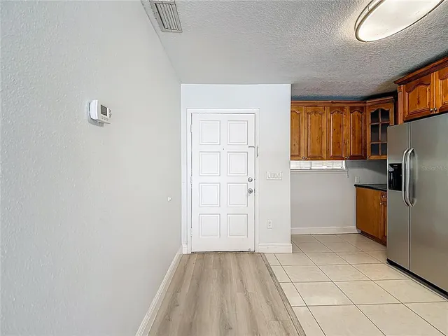 a view of a kitchen with a sink and a refrigerator