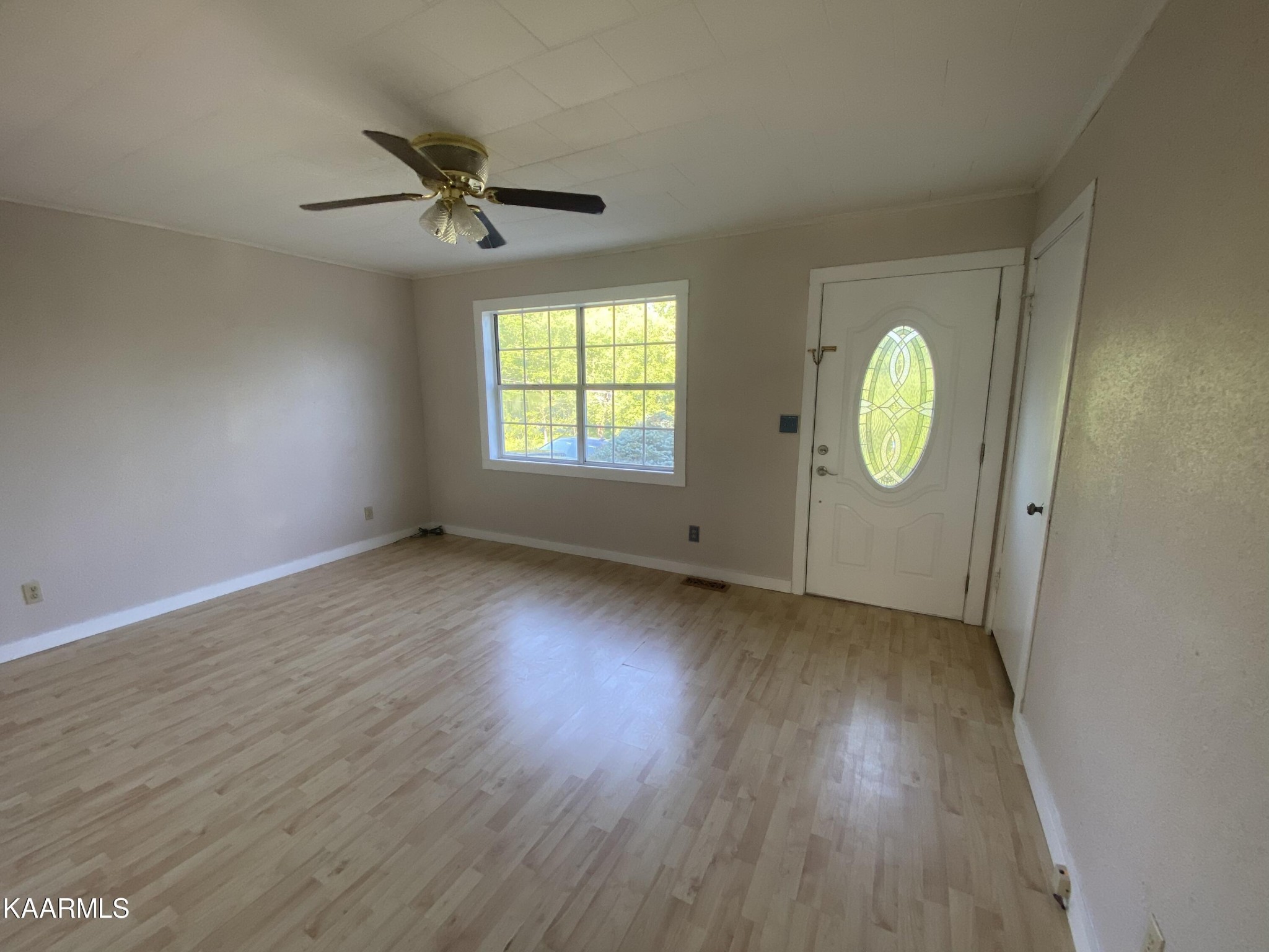 132 Dustin Lane Oneida, TN 37841 - Photo 13 of 27 an empty room with wooden floor and windows