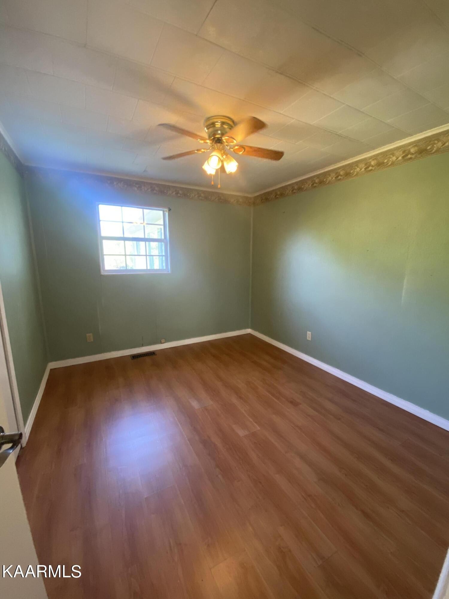 132 Dustin Lane Oneida, TN 37841 - Photo 19 of 27 a view of an empty room with wooden floor and a window