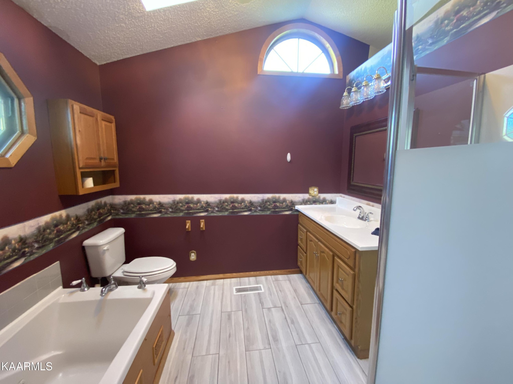 132 Dustin Lane Oneida, TN 37841 - Photo 22 of 27 a spacious bathroom with a granite countertop sink a mirror and toilet