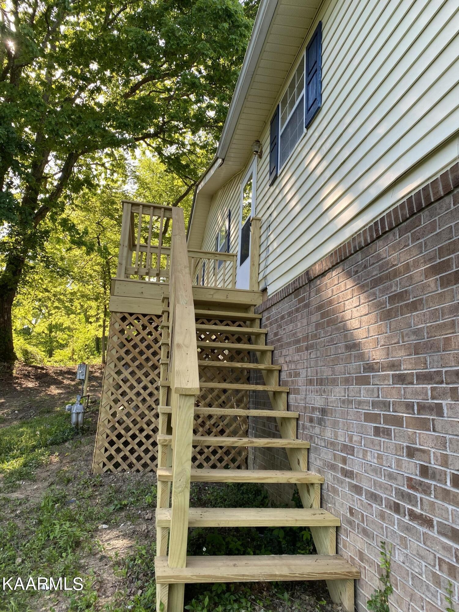 132 Dustin Lane Oneida, TN 37841 - Photo 4 of 27 a view of wooden house with a door
