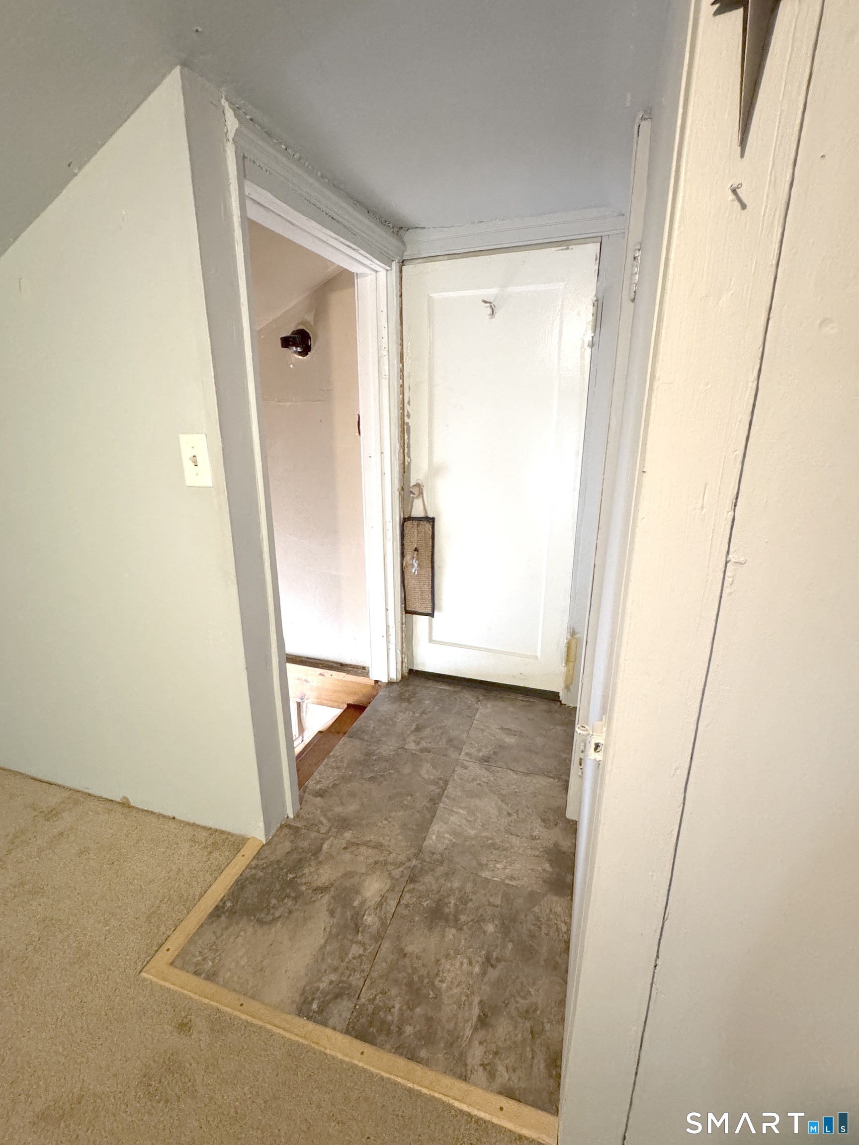 6-8 Vose Street Ansonia, CT 06401 - Photo 34 of 37 3rd level landing and stairs leading back to 2nd floor main entrance. other door in landing leads to attic/storage