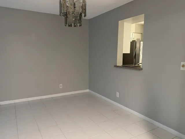 a sign on the side of the grass and the wall