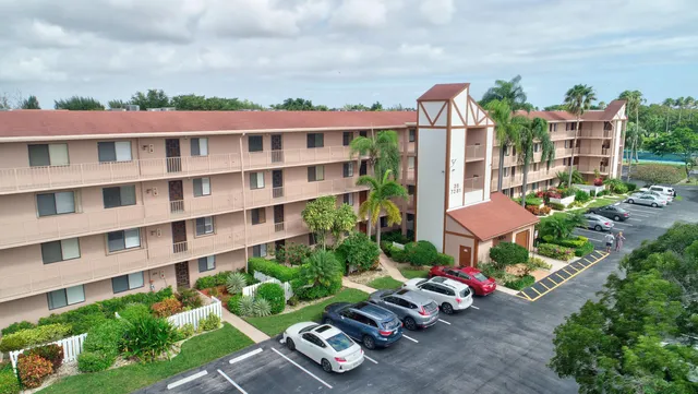 a view of an empty room and chandelier fan