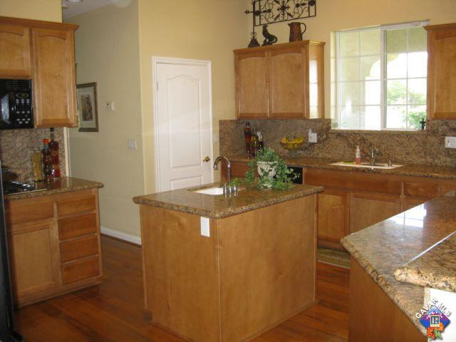 245 Raven Drive Palmdale, CA 93551 - Photo 4 of 10 a kitchen with stainless steel appliances granite countertop a sink stove and cabinets