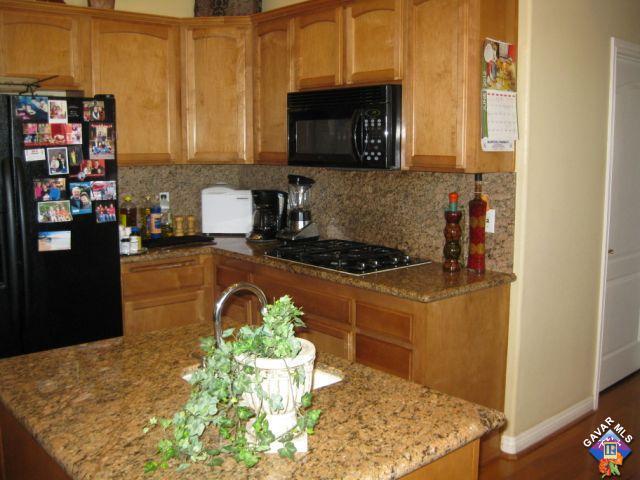 245 Raven Drive Palmdale, CA 93551 - Photo 5 of 10 a kitchen with a stove and a microwave