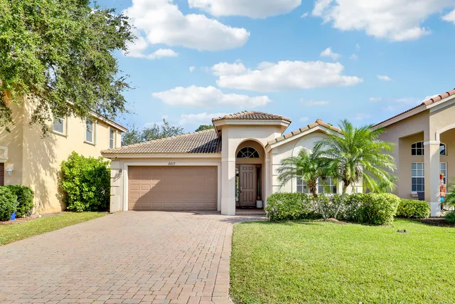 a front view of a house with a yard and garage