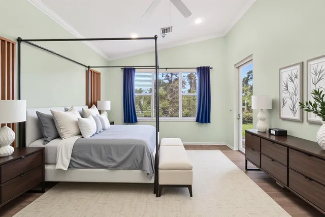 a bedroom with a large bed and a chandelier