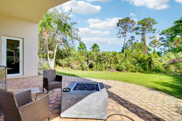 a view of a backyard with plants and a patio