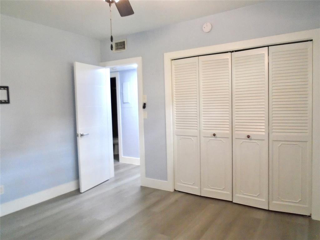 1991 Northeast 32nd Street, Unit 18 Lighthouse Point, FL 33064 - Photo 11 of 39 wooden floor in an empty room