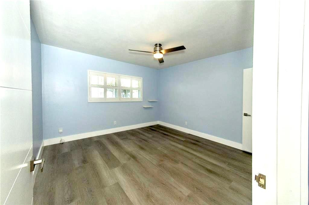 1991 Northeast 32nd Street, Unit 18 Lighthouse Point, FL 33064 - Photo 13 of 39 an empty room with a window and a ceiling fan