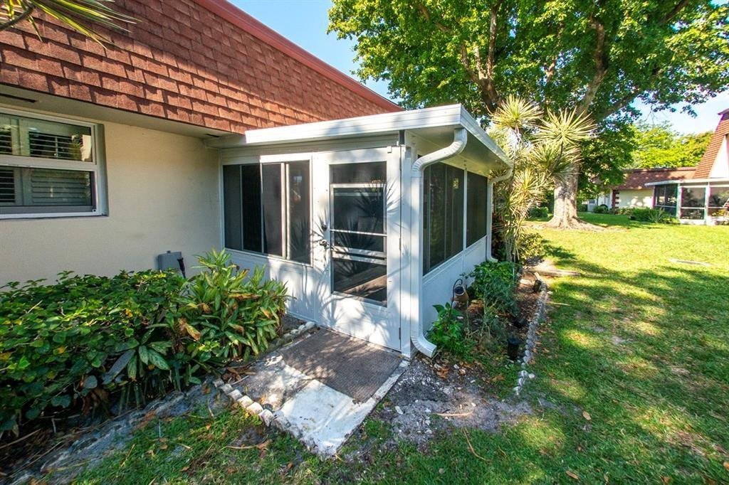 1991 Northeast 32nd Street, Unit 18 Lighthouse Point, FL 33064 - Photo 25 of 39 a front view of a house with garden