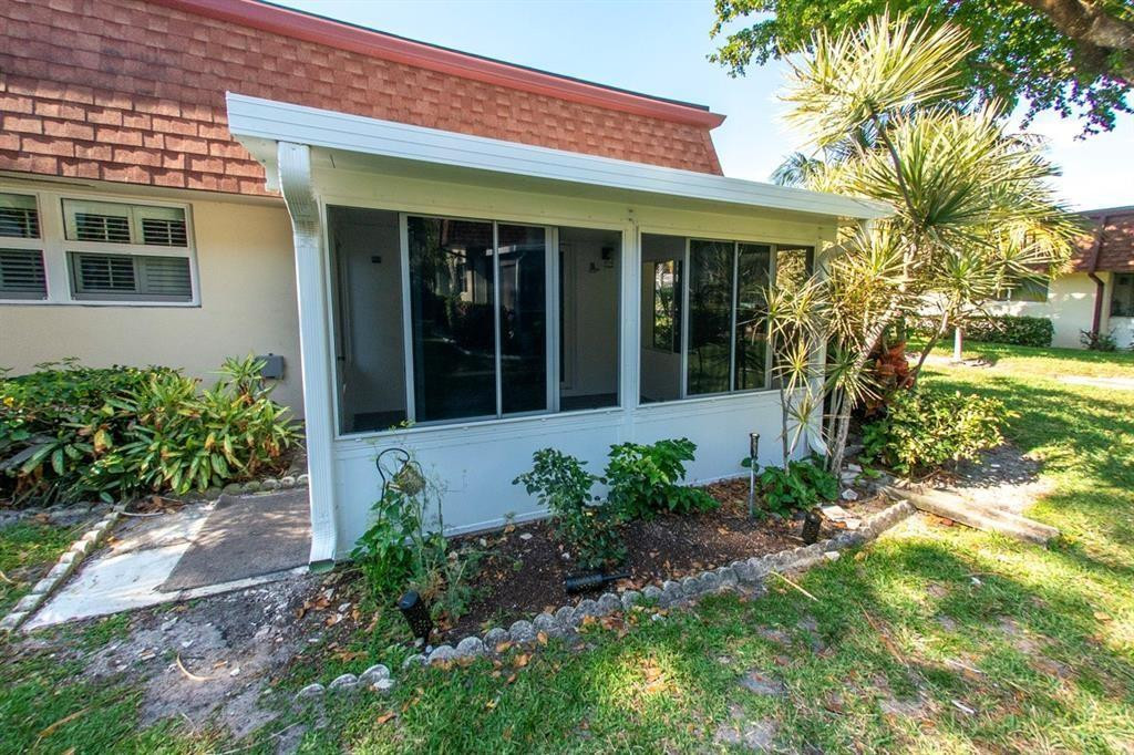 1991 Northeast 32nd Street, Unit 18 Lighthouse Point, FL 33064 - Photo 26 of 39 a front view of a house with garden